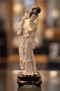 Asian Female Sculpture with Floral Details on Dark Display Stand