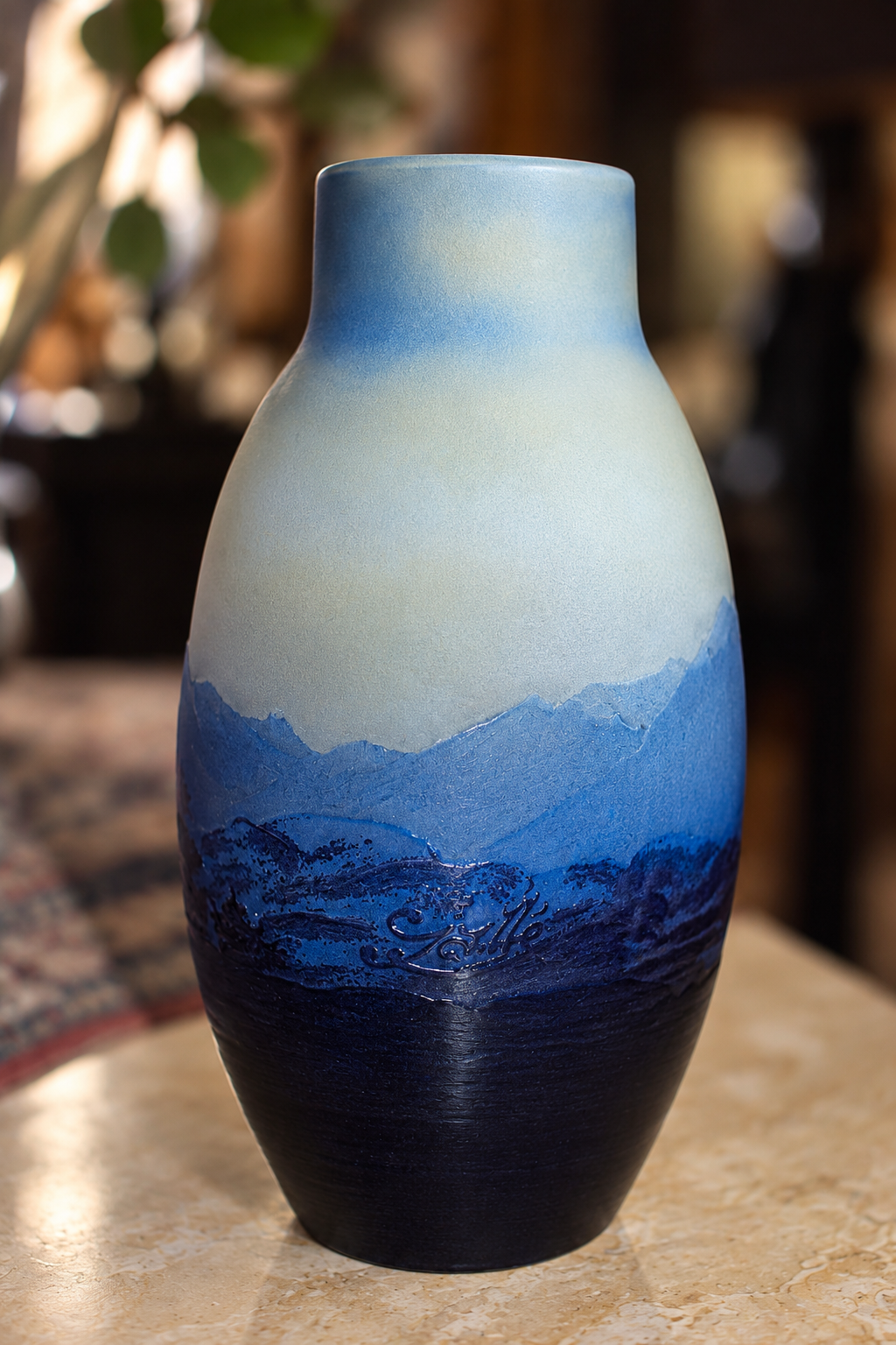 Reverse view of Émile Gallé signed Art Nouveau cameo glass vase showing the carved Gallé signature, blue mountain landscape graduation from navy to sky blue